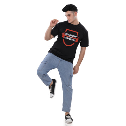 A man wearing a NutraStore natural supplement brand black t-shirt with a graphic print in the center, running and holding a basketball.